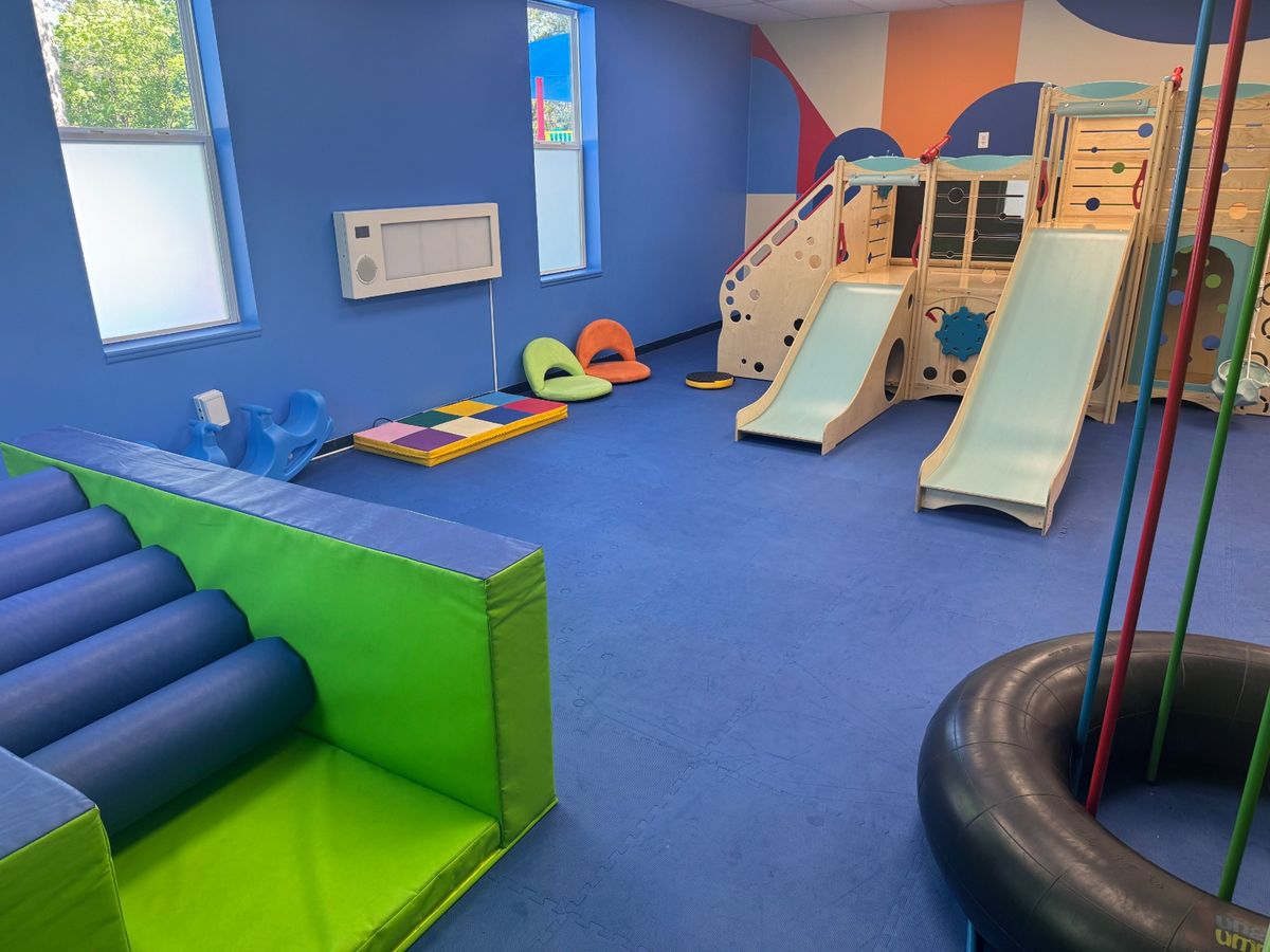 Circle time room with colorful mural, cubbies, and bean bags