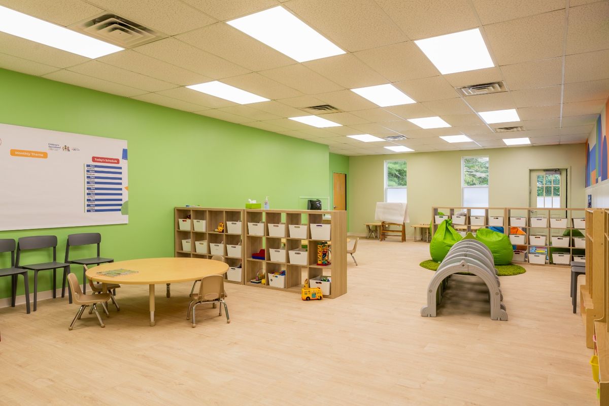 Classroom with cubbies, play tunnel, and activity table