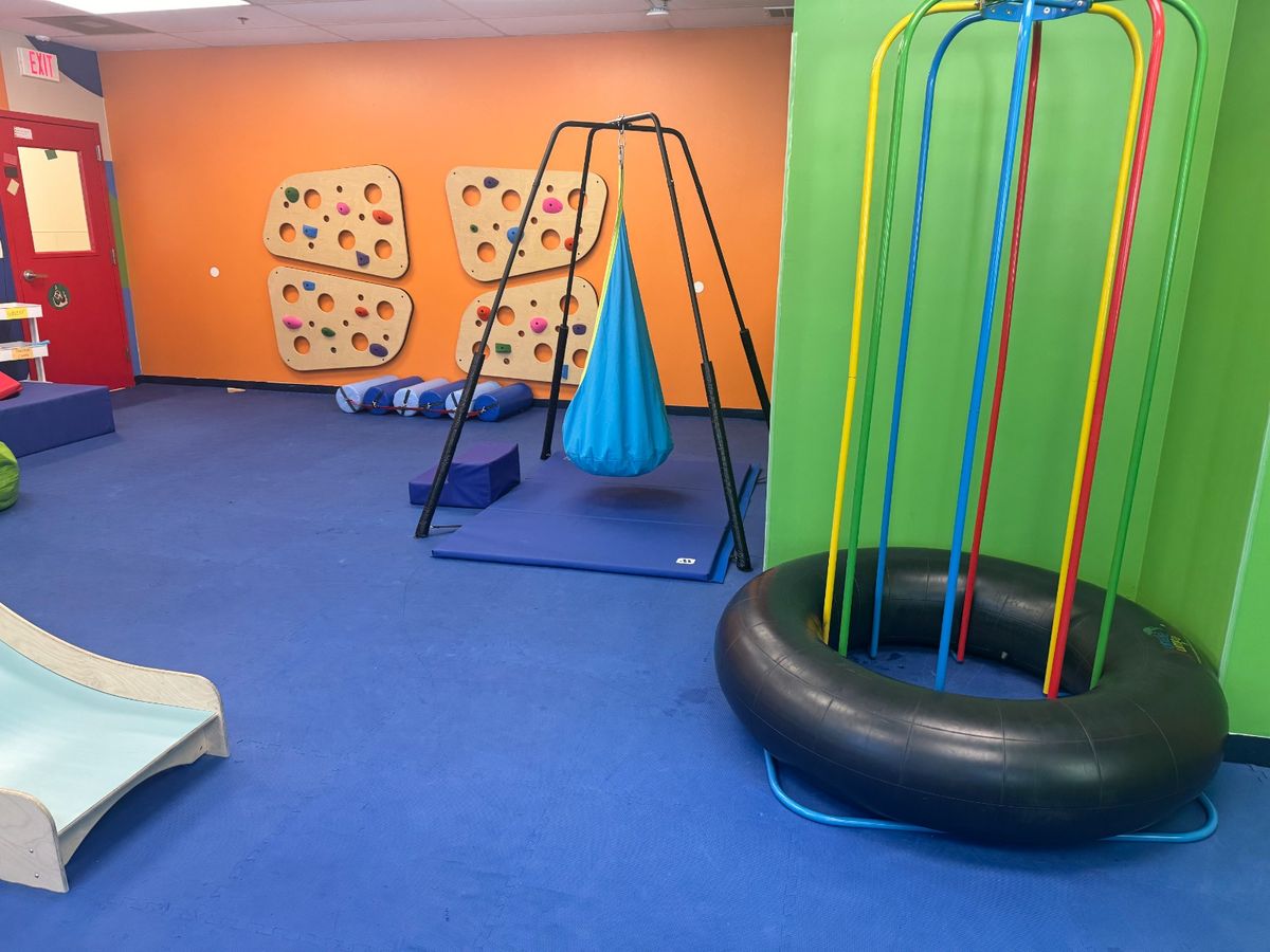 Play area with slide, foam stairs, and movement equipment