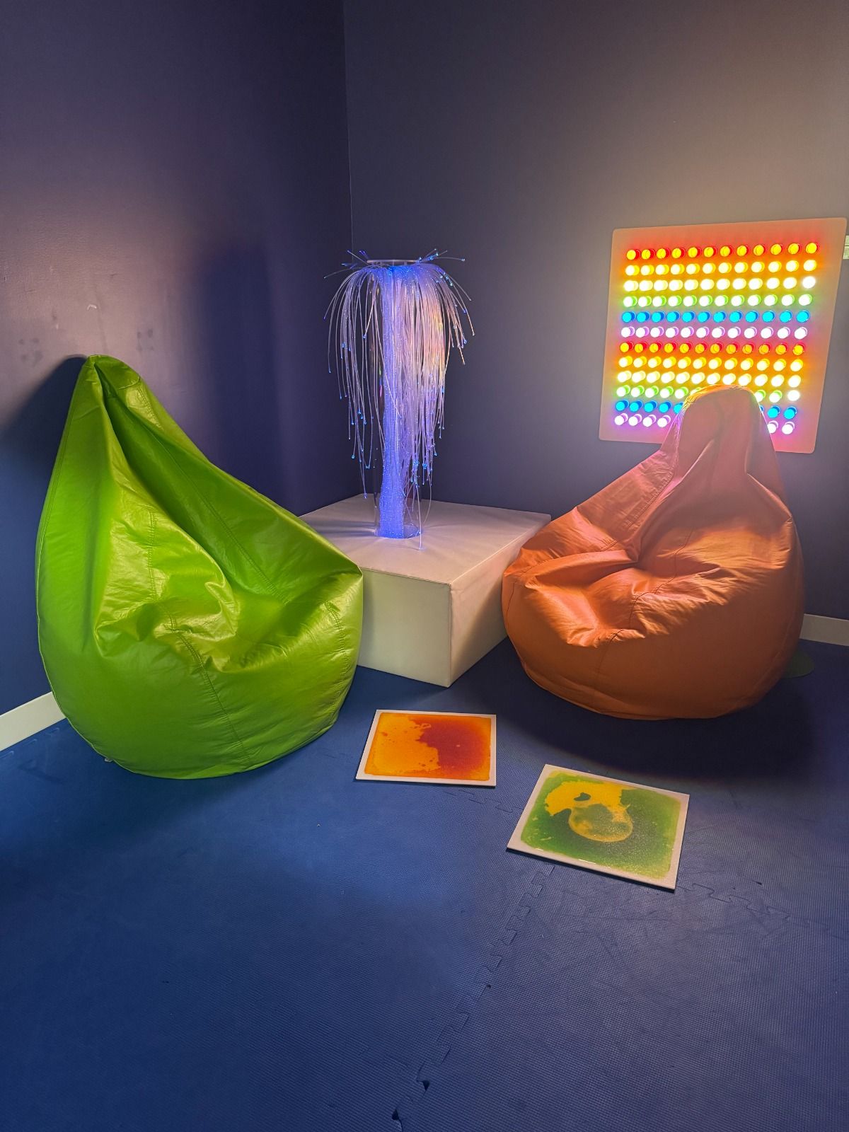 Gym with climbing wall, sensory swing, and balance equipment