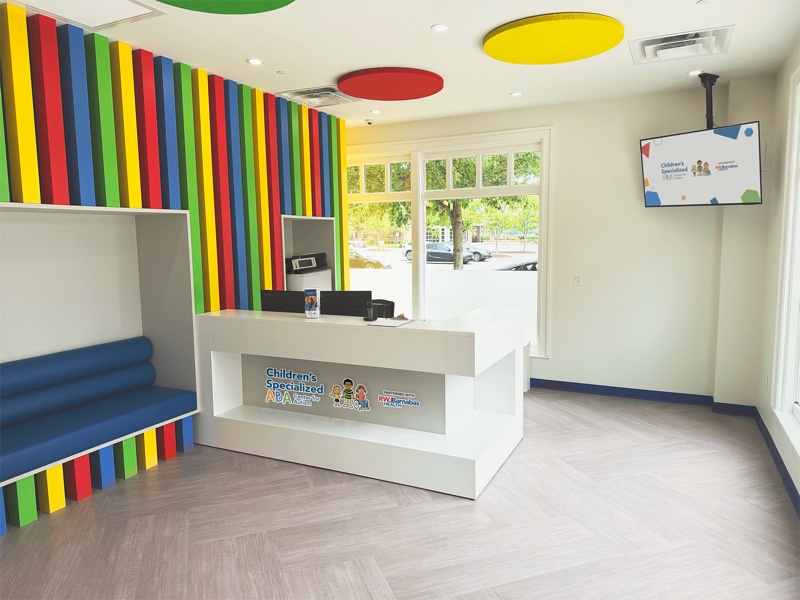 Classroom with cubbies, play tunnel, and activity table