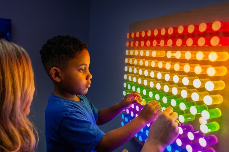 Sensory room with fiber optic lamp, LED light board, and bean bags